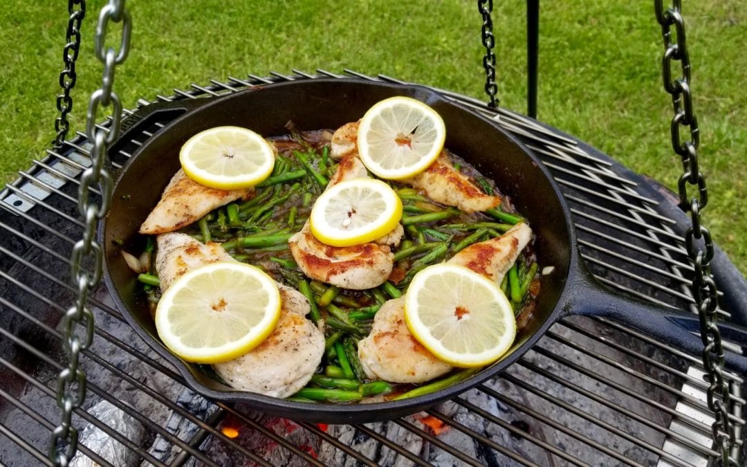 Paleo Lemon Chicken and Asparagus in a cast iron skillet