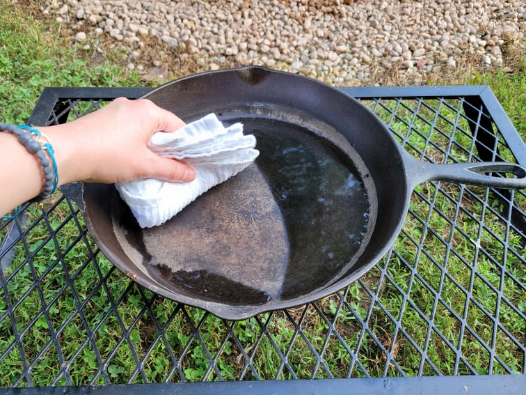 Wiping cast iron skillet dry with a towel