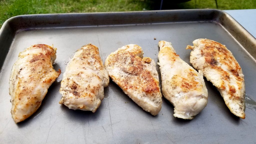 browned chicken breasts on a cooking sheet