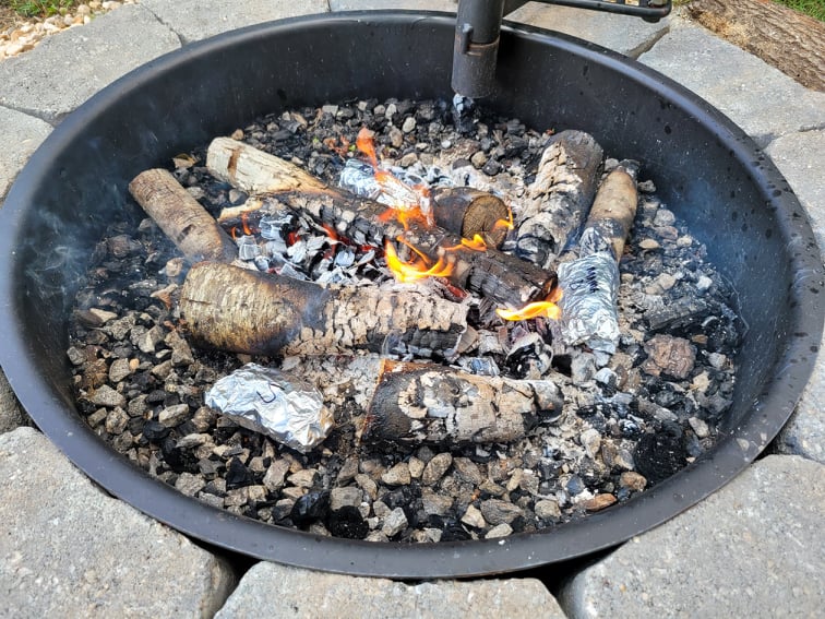 campfire breakfast burritos cooking in fire pit