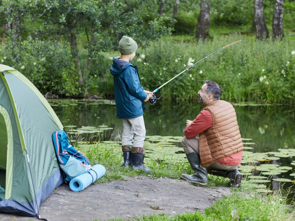 a father and son camping and fishing