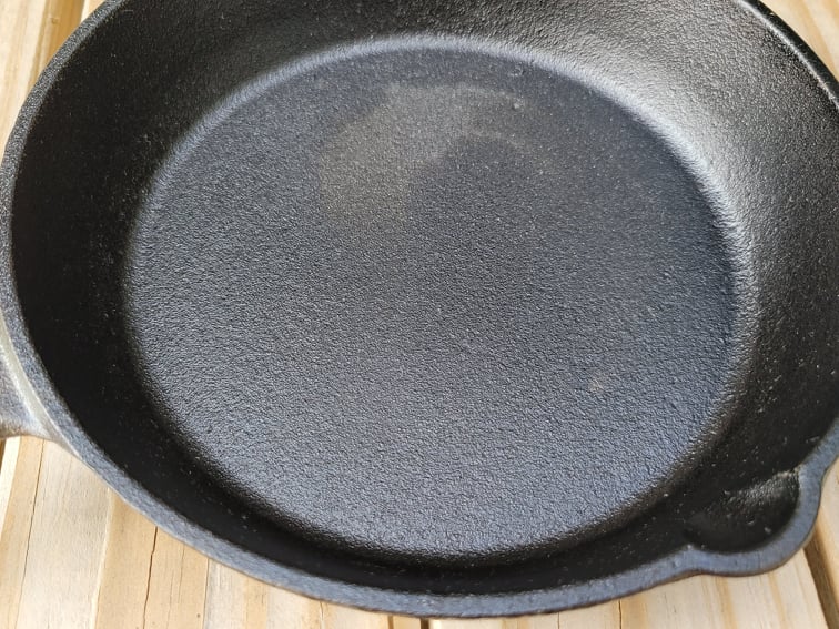 New, pre-seasoned skillet with a rough-textured surface