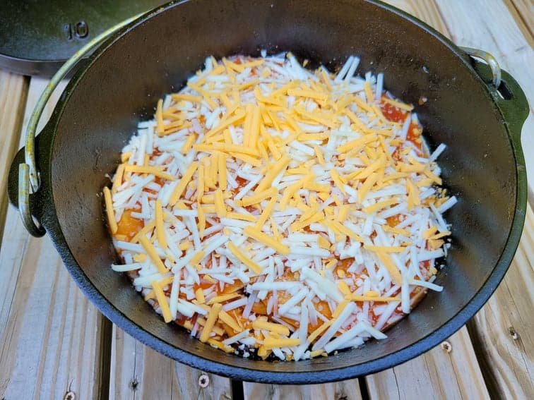 Prepared dutch oven enchilada casserole ready to be cooked