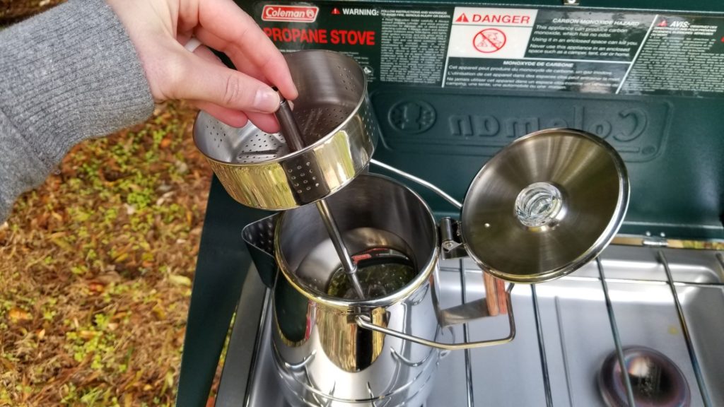 removing the strainer basket from a camping percolator pot