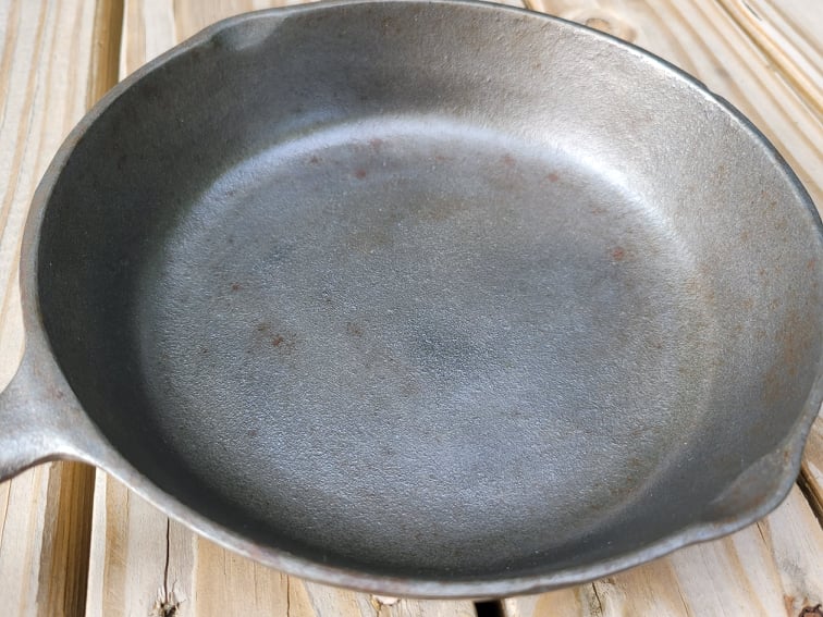 unseasoned, silver-colored cast iron skillet