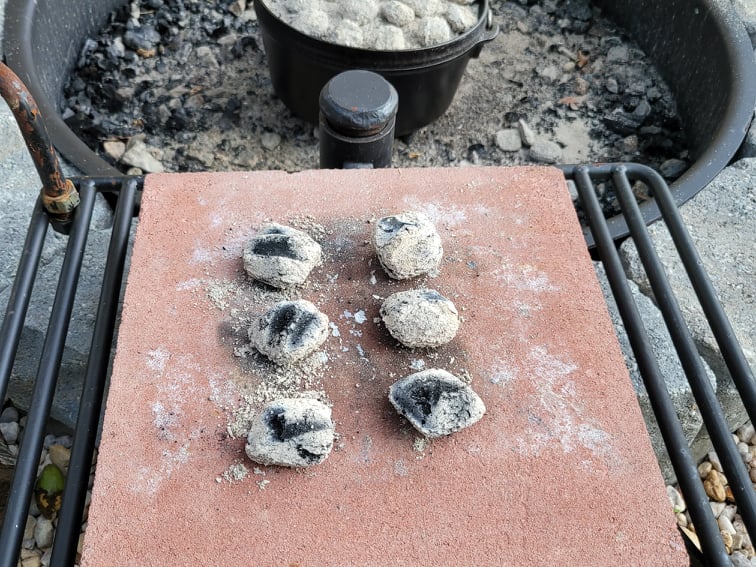 Charcoal briquettes on a cooking brick