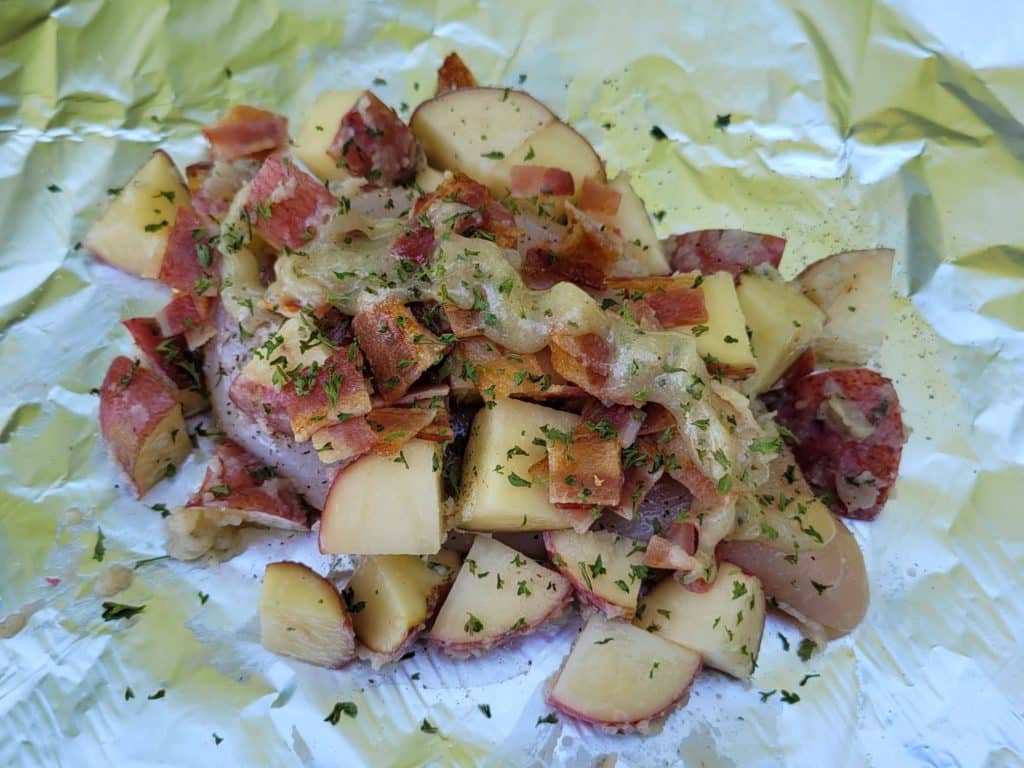 chicken, potatoes, bacon, parsley, and ranch-butter prepared for foil packet cooking