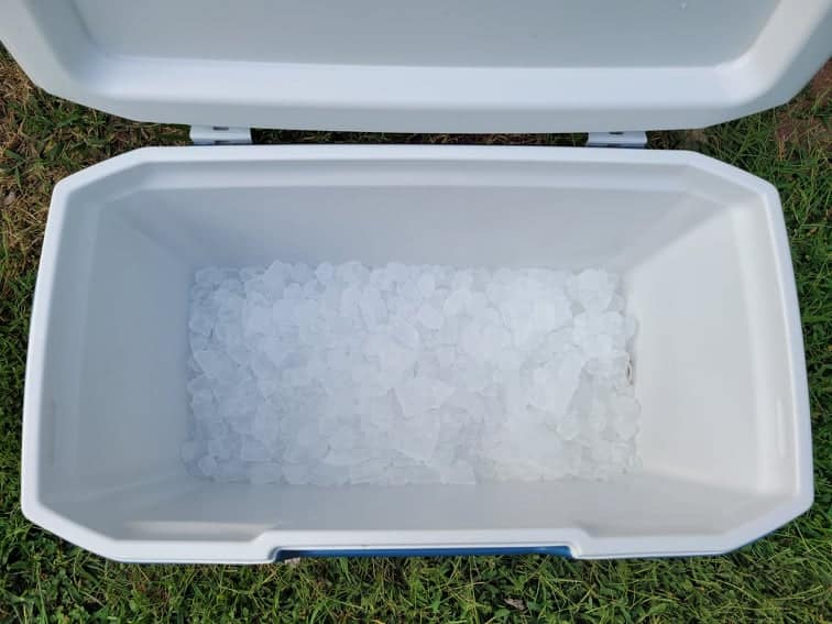 large cooler partially filled with ice 