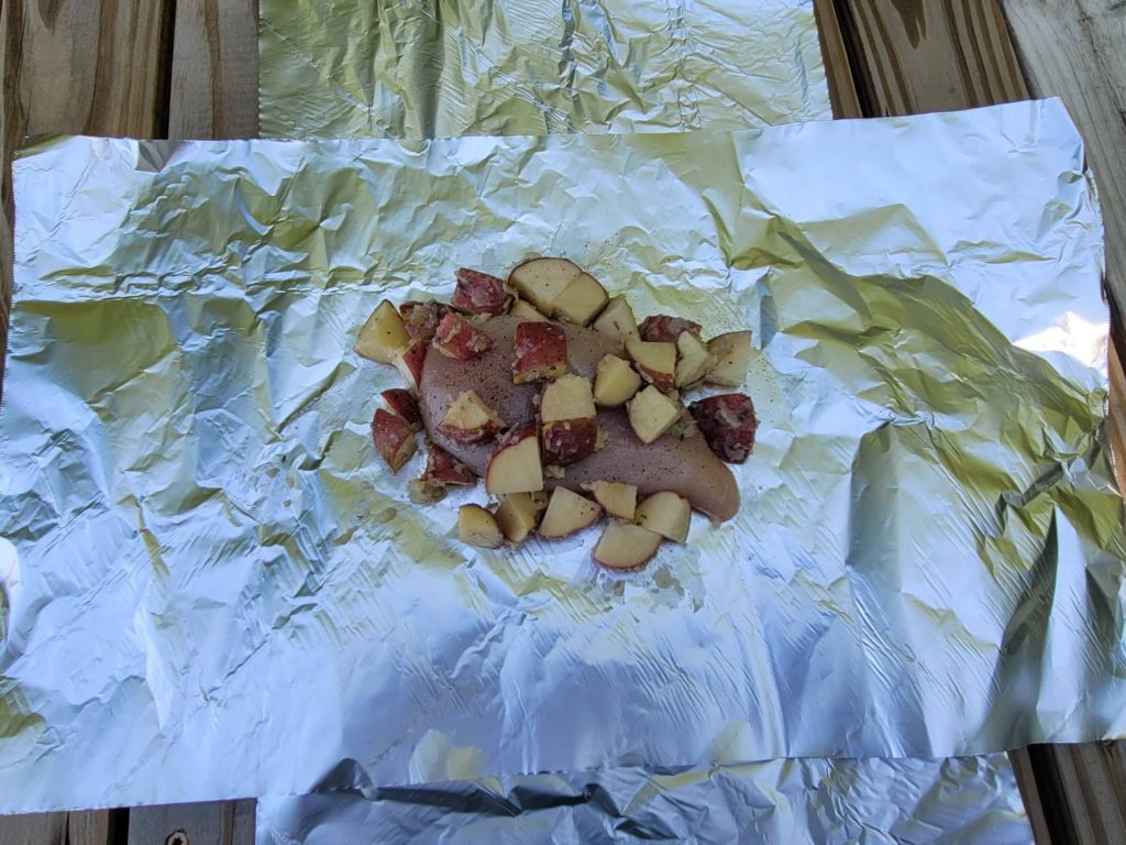 chicken and potatoes on foil 