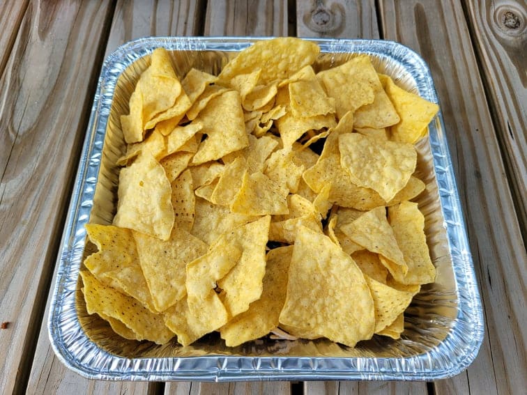 Layered tortilla chips and nacho ingredients 
