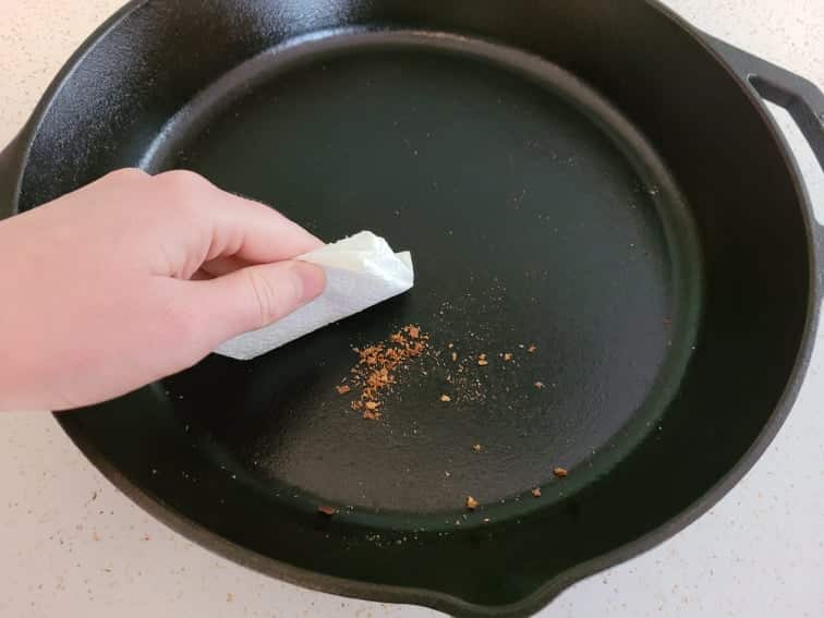 wiping crumbs out of cast iron skillet 