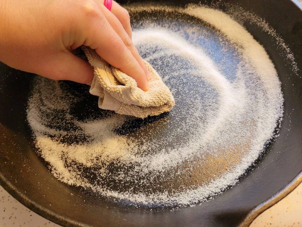 Salt scrub to remove sticky oil from cast iron