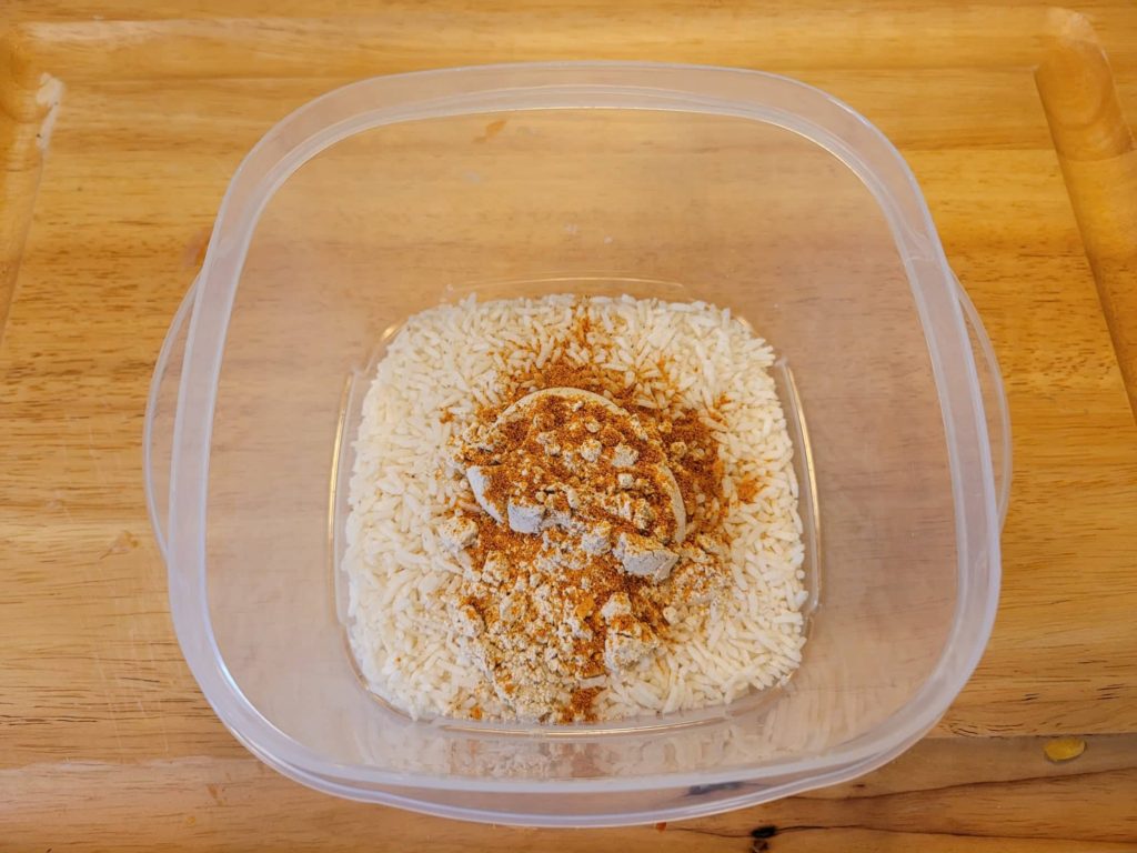 dry rice and fajita seasoning in a plastic container 