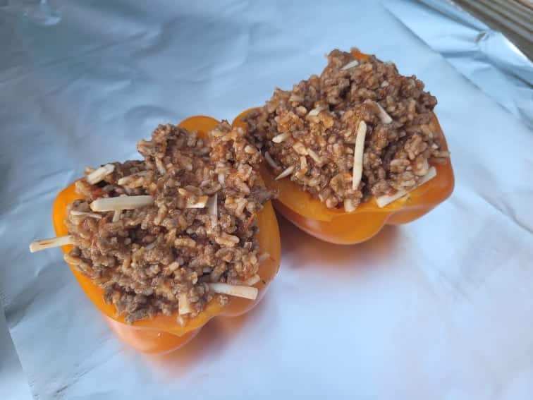 prepared stuffed peppers on aluminum foil prior to cooking