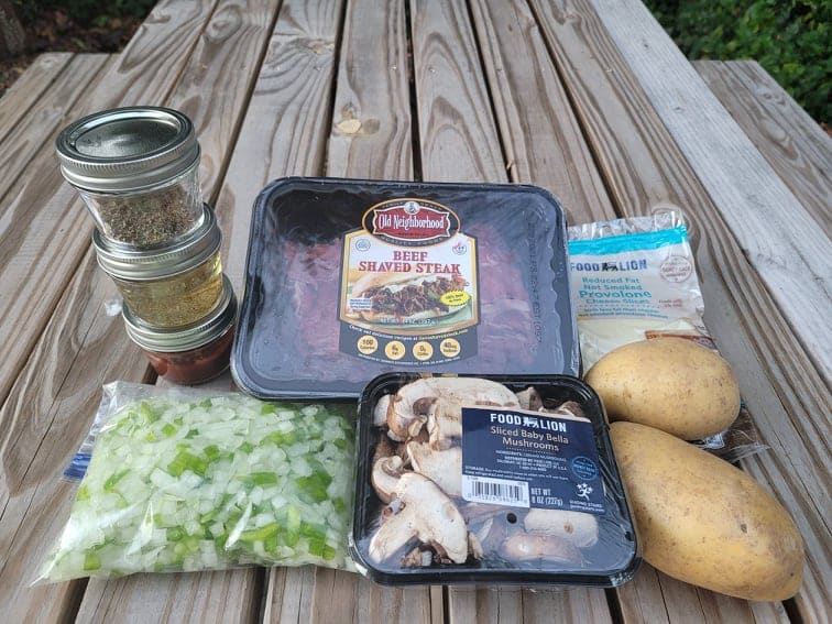philly cheesesteak ingredients on a picnic table 