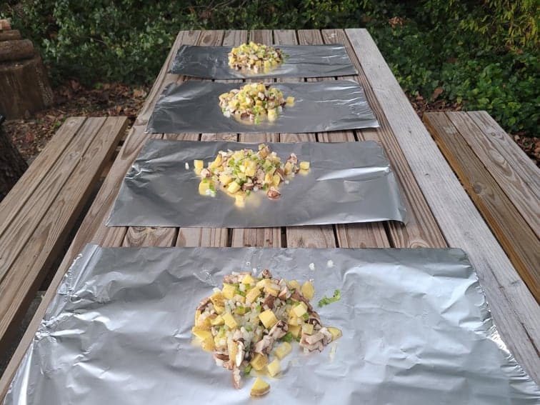 Dinner ingredients on aluminum foil sheets to be prepared for foils packet meals
