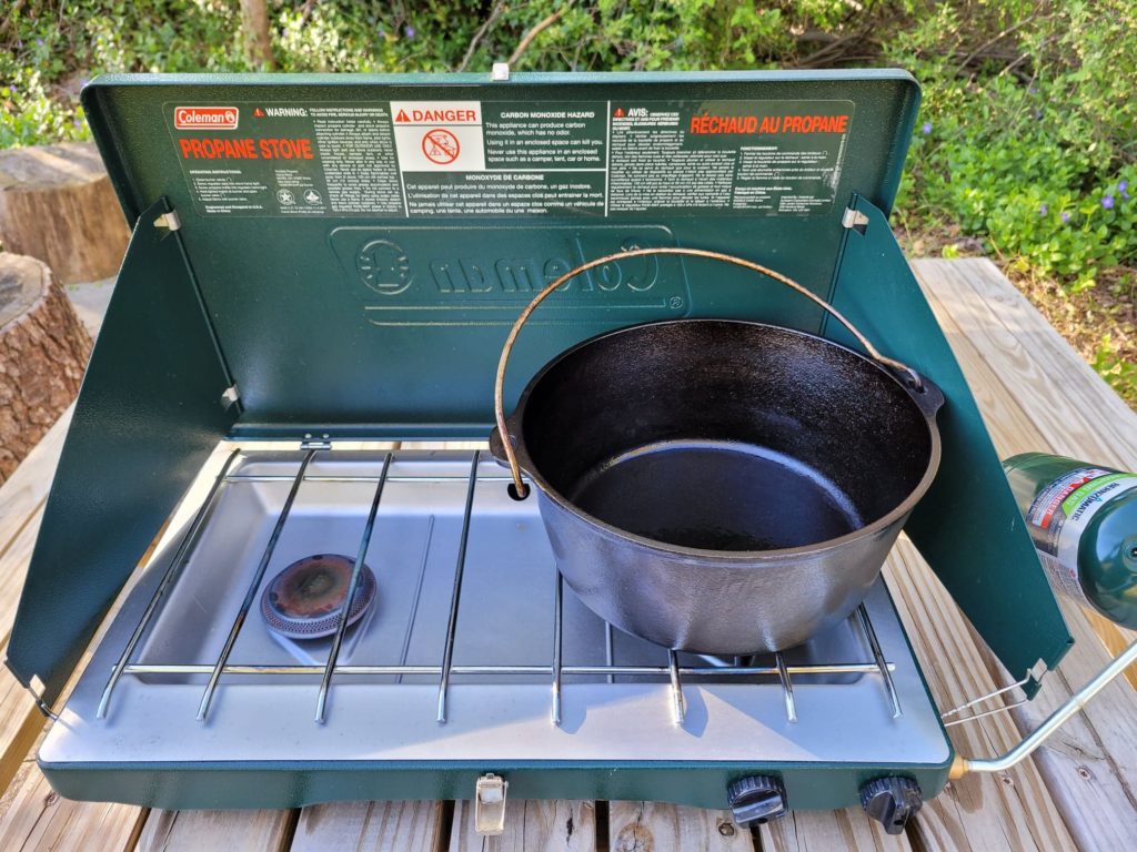 dutch oven preheating on a camp stove