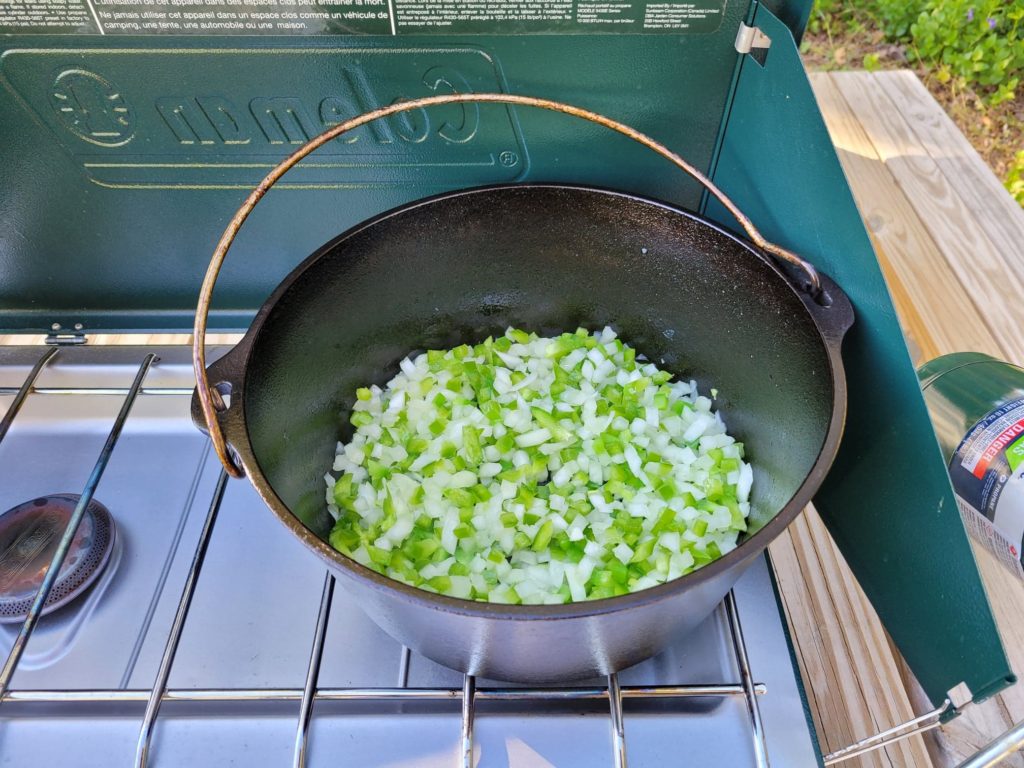 sauteing diced peppers and onions in a dutch oven 