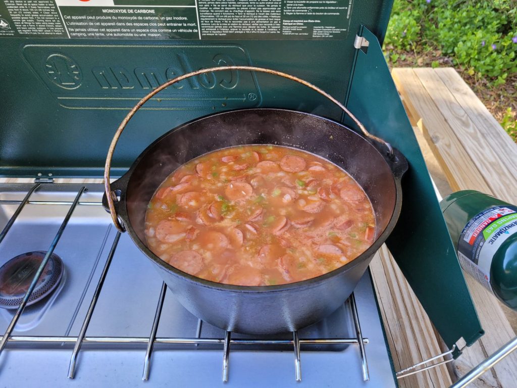 cajun sausage and rice simmering in a dutch oven