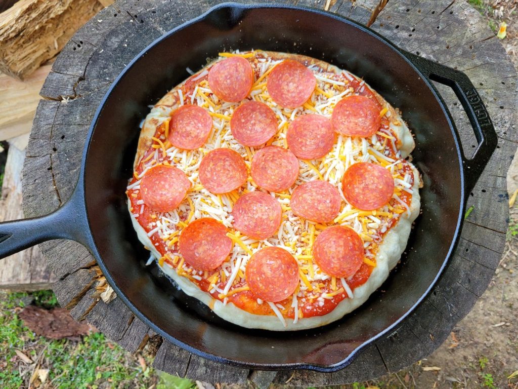 Prepared campfire skillet pizza with toppings prior to cooking 