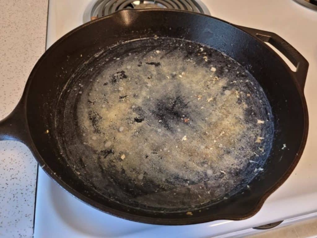 Food residue stuck on a cast iron pan
