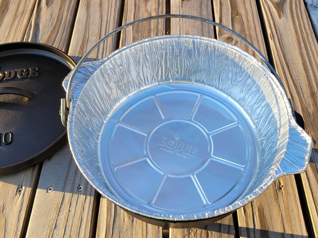 placing an aluminum liner in the dutch oven