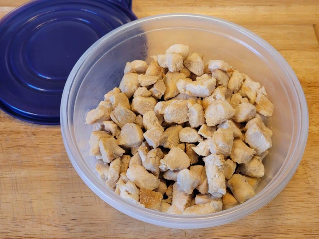 cooked chicken in a plastic container