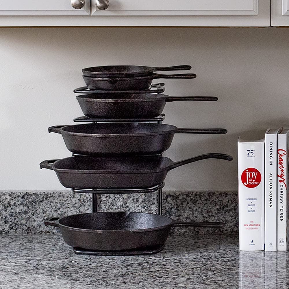 countertop cast iron cookware organizer with pans stacked on racks