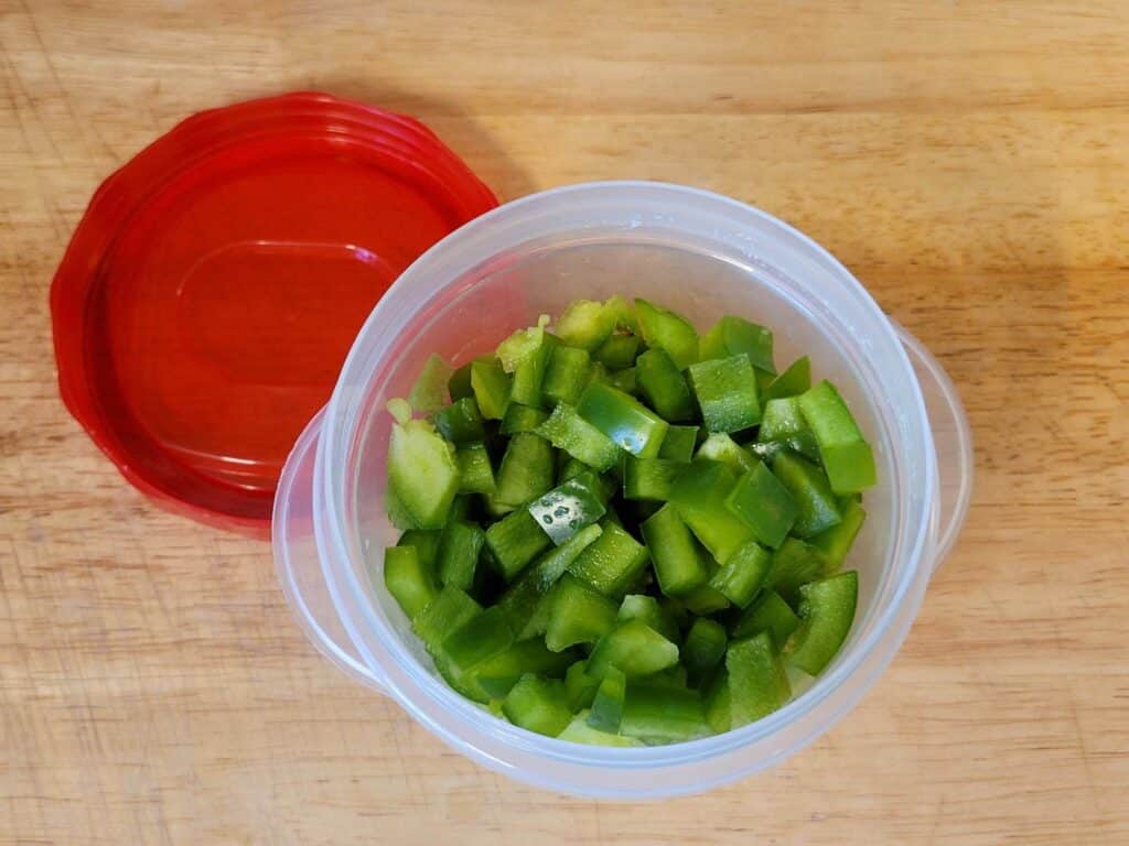 diced green bell pepper in a small plastic container