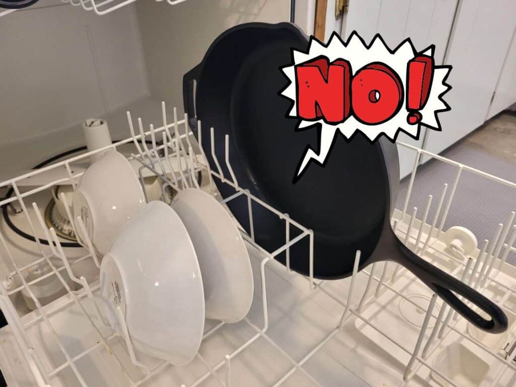 cast iron skillet in dishwasher with a red "NO" sign