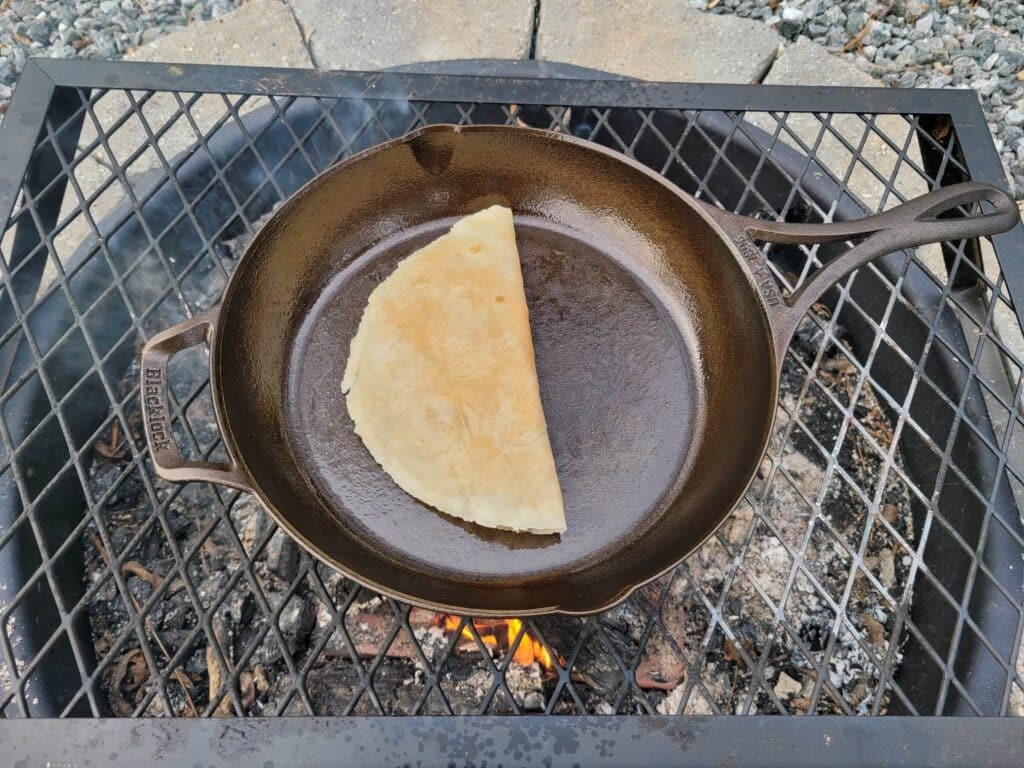 flipped quesadilla cooking in skillet