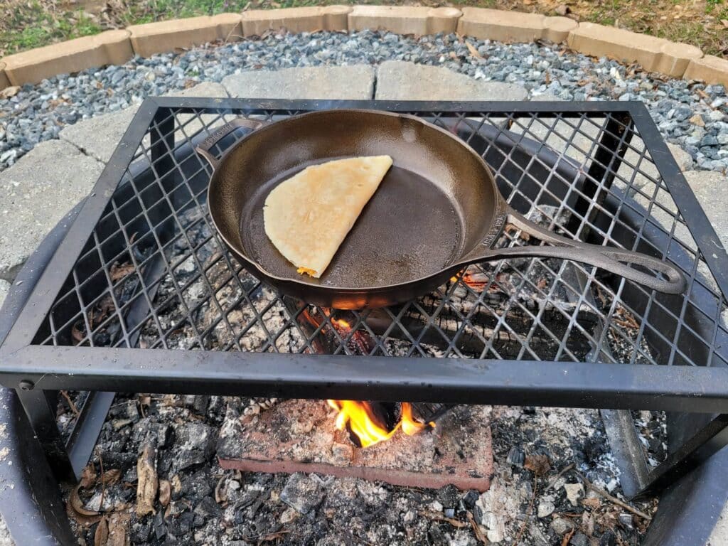 folded buffalo chicken quesadilla cooking in a cast iron skillet 